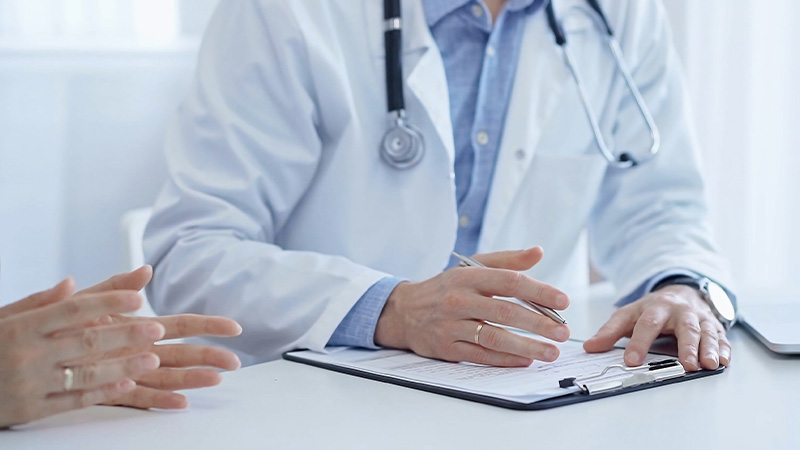 medico che scrive su cartella