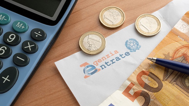 soldi e calcolatrice e carta intestata agenzia delle entrate