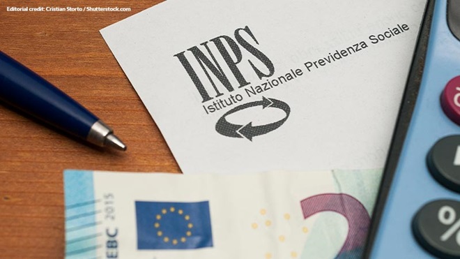 foglio INPS con penna calcolatrice e soldi su tavolo di legno